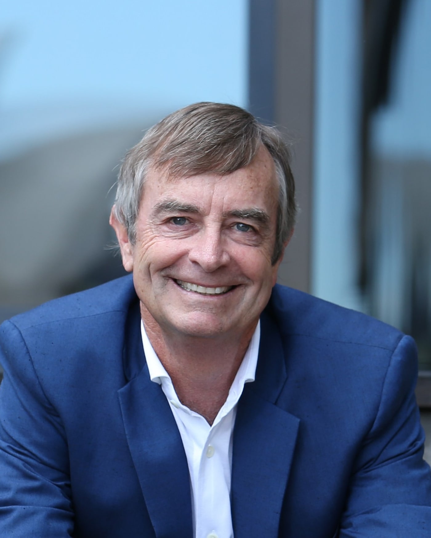 Dane Hudson smiling, photographed by Sydney Harbour